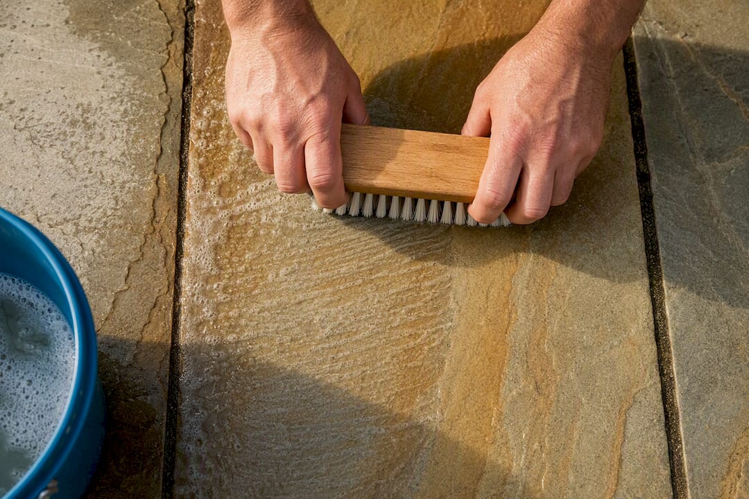 Nylon brush scrubbing sandstone grain